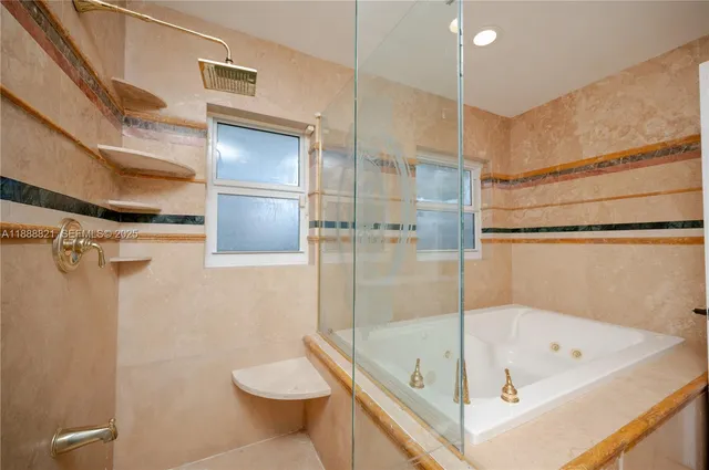 a bathroom with a tub and a shower