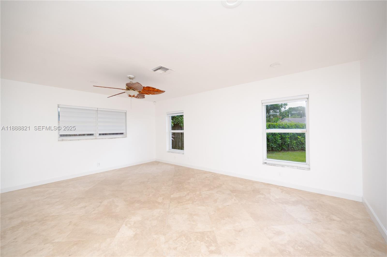 9881 Southwest 1st Court Plantation, FL 33324 - Photo 25 of 52 an empty room with a window and a ceiling fan