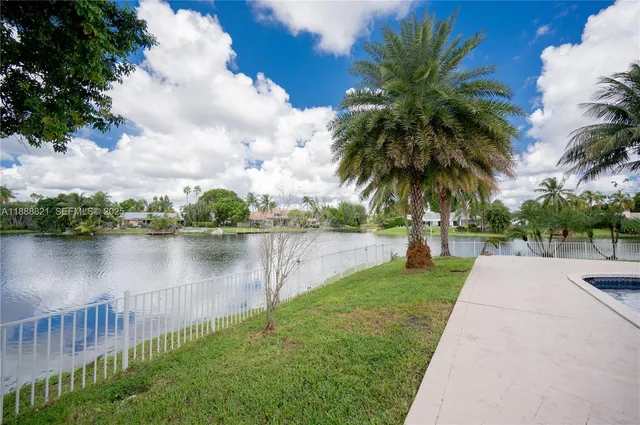 a view of an empty room with chandelier fan