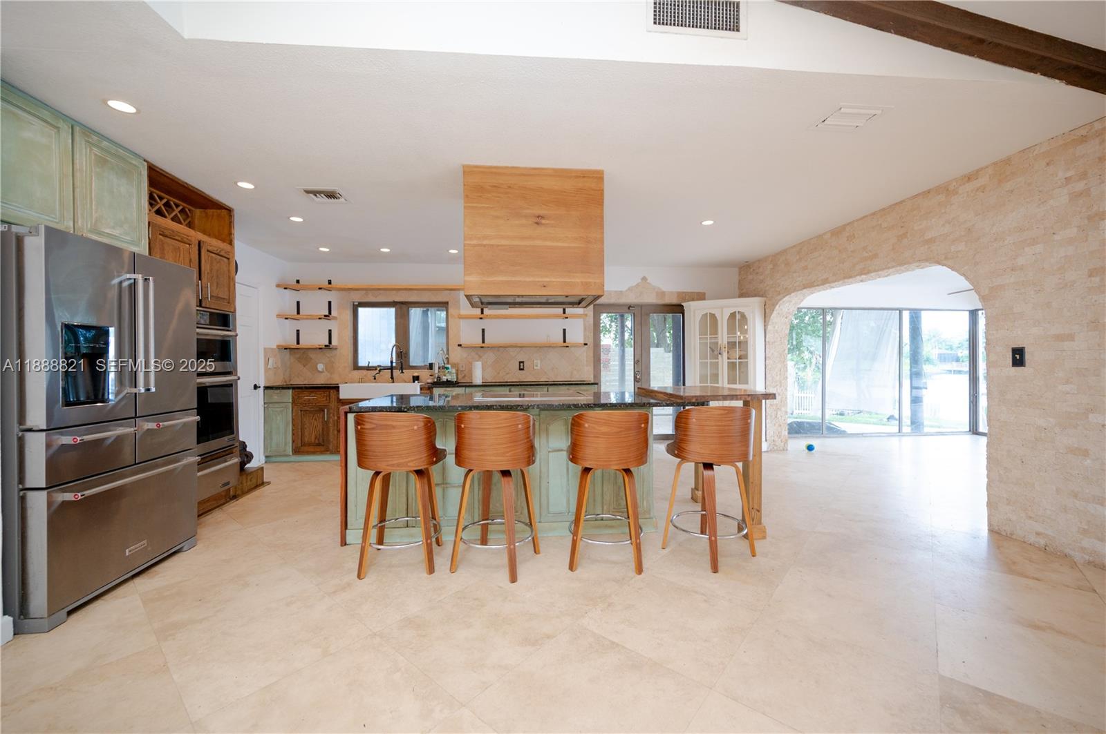 9881 Southwest 1st Court Plantation, FL 33324 - Photo 29 of 52 a open kitchen with stainless steel appliances kitchen island granite top and refrigerator