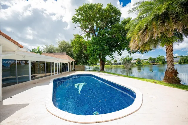 a view of a house with swimming pool and a yard