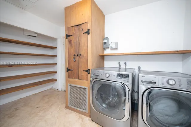 a view of an empty room with chandelier fan and wooden floor