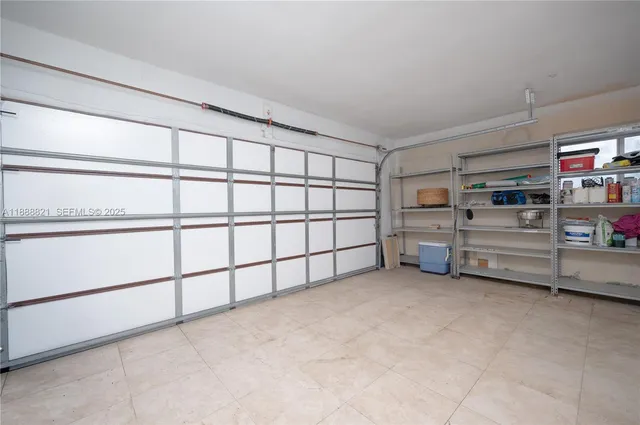 an aerial view of a house with a garden and lake view