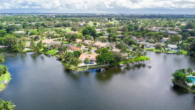 an aerial view of a lake with green space
