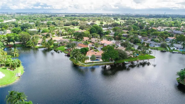 an aerial view of a house with a lake view