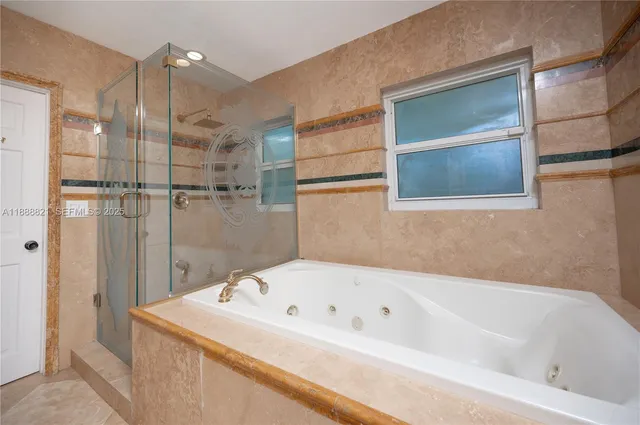 a bathroom with a bathtub and shower