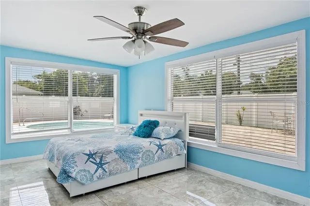 a bedroom with a large bed and a large window