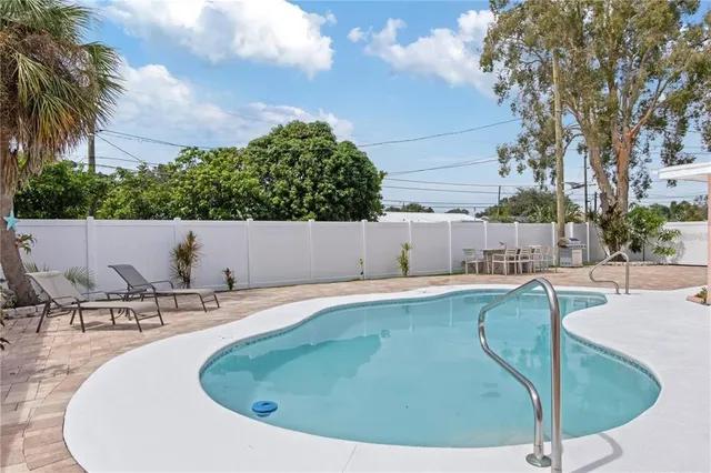 a view of a swimming pool with chairs