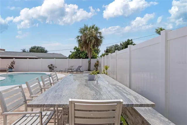 a view of a swimming pool with chairs
