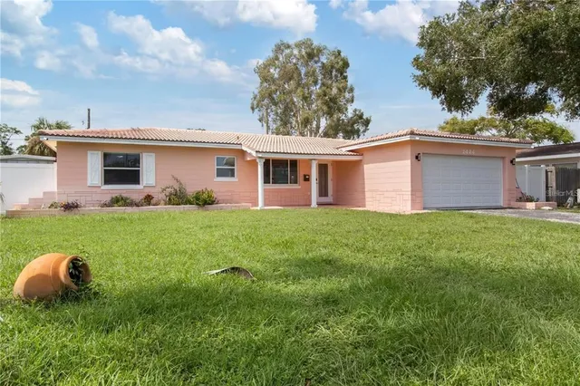 a front view of house with yard and green space
