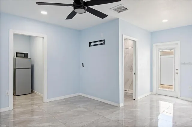 a kitchen with granite countertop white cabinets and a sink