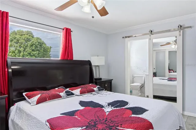 a bedroom with a bed closet and a large window