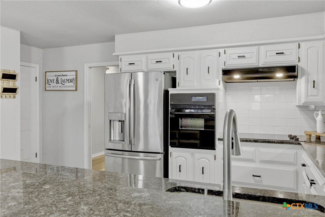 1710 Old Mill Road, Unit 12 Salado, TX 76571 - Photo 17 of 42 a kitchen with stainless steel appliances a refrigerator and cabinets