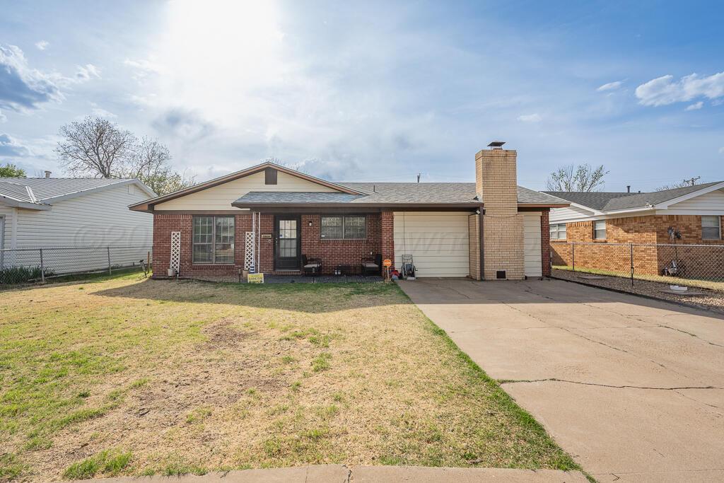 2910 Browning Street Amarillo, TX 79103 - Photo 1 of 28 a front view of a house with a yard and garage