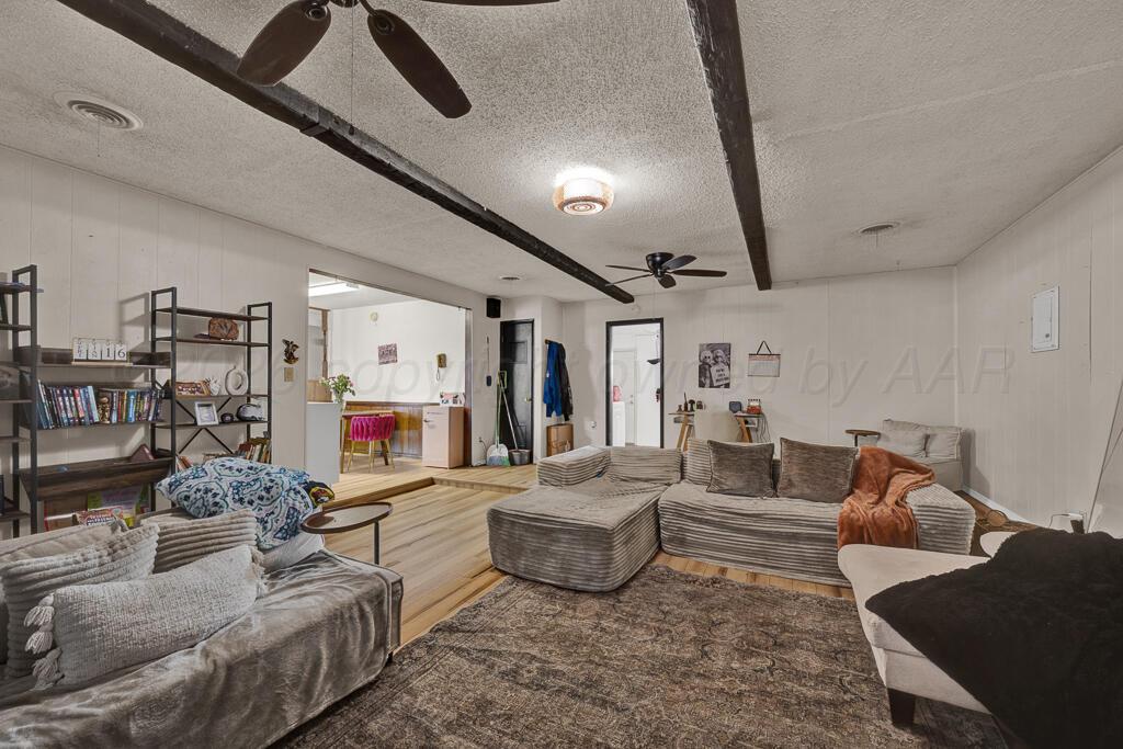 2910 Browning Street Amarillo, TX 79103 - Photo 11 of 28 a living room with furniture and a flat screen tv