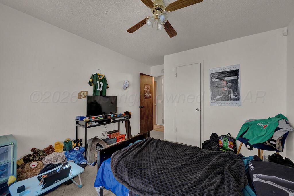 2910 Browning Street Amarillo, TX 79103 - Photo 15 of 28 a bed room with a bed and a chair