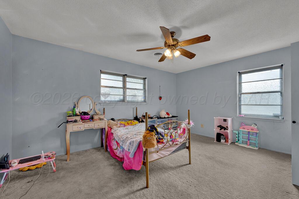 2910 Browning Street Amarillo, TX 79103 - Photo 16 of 28 a bedroom with furniture and a window