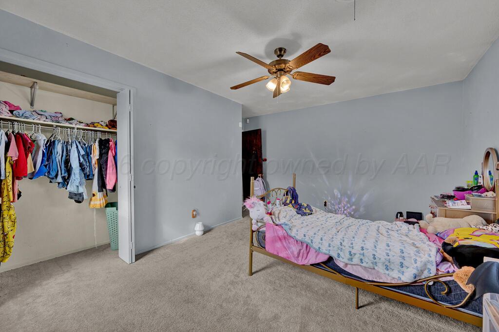 2910 Browning Street Amarillo, TX 79103 - Photo 17 of 28 a bedroom with furniture and a fan