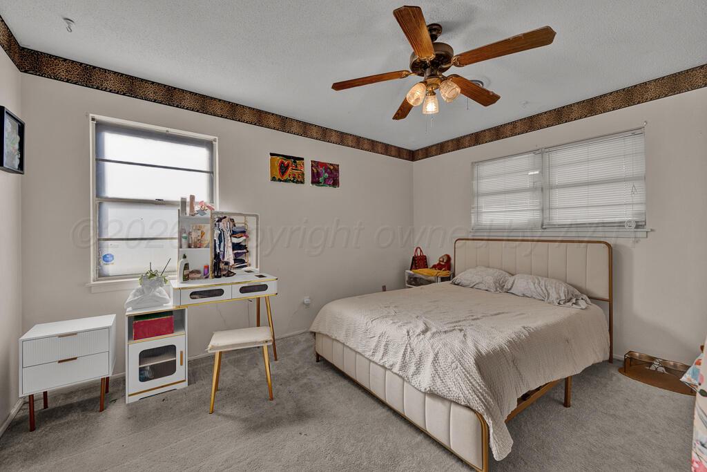 2910 Browning Street Amarillo, TX 79103 - Photo 18 of 28 a bedroom with a bed and a table