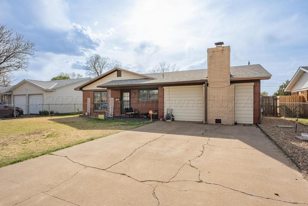 2910 Browning Street Amarillo, TX 79103 - Photo 2 of 28 a front view of a house with a yard and garage