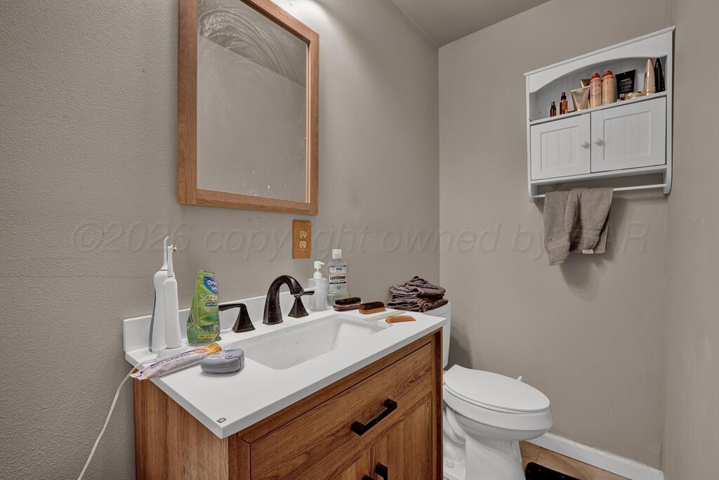 2910 Browning Street Amarillo, TX 79103 - Photo 26 of 28 a bathroom with a sink and a toilet