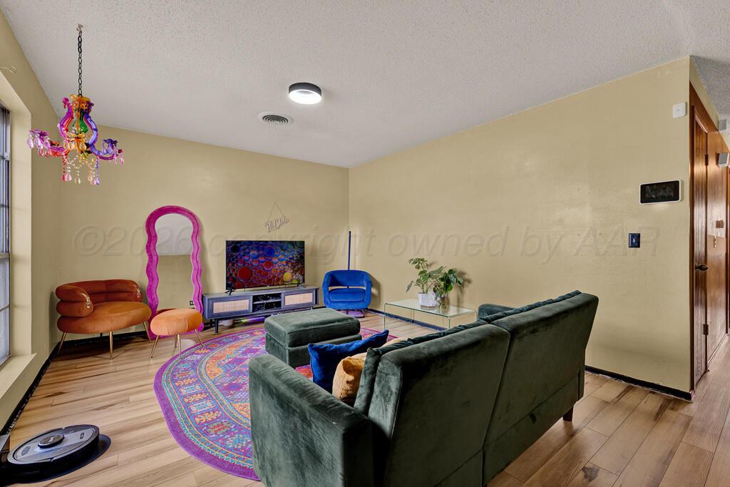 2910 Browning Street Amarillo, TX 79103 - Photo 4 of 28 a living room with furniture and a wooden floor