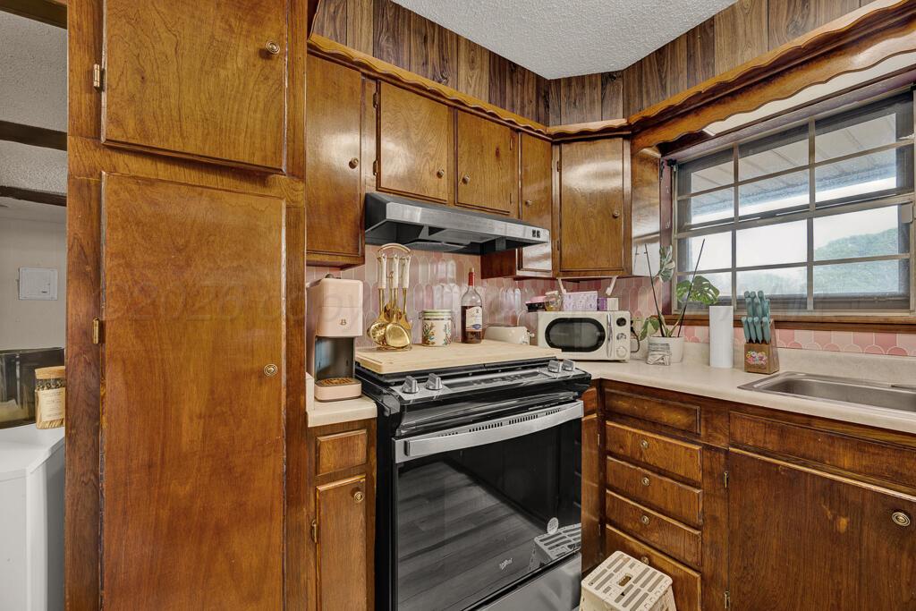 2910 Browning Street Amarillo, TX 79103 - Photo 9 of 28 a kitchen with stainless steel appliances granite countertop a sink a stove and a refrigerator