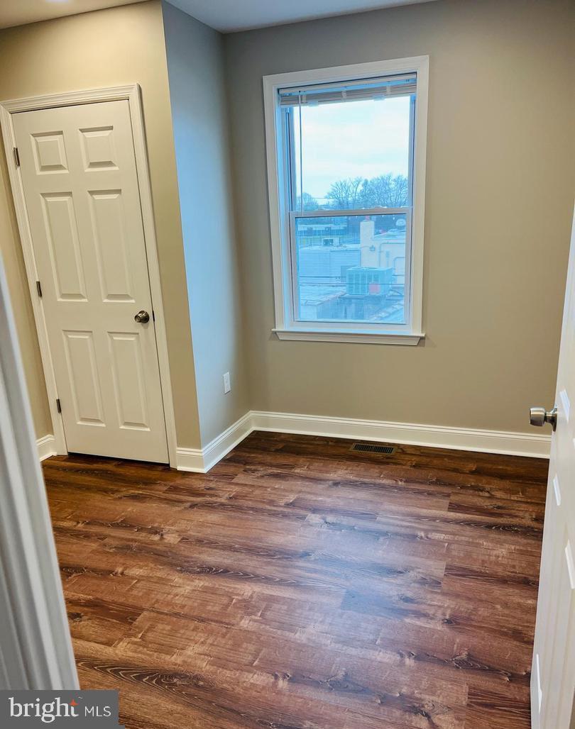 424 North Springfield Road Clifton Heights, PA 19018 - Photo 13 of 24 a view of an empty room with wooden floor and a window