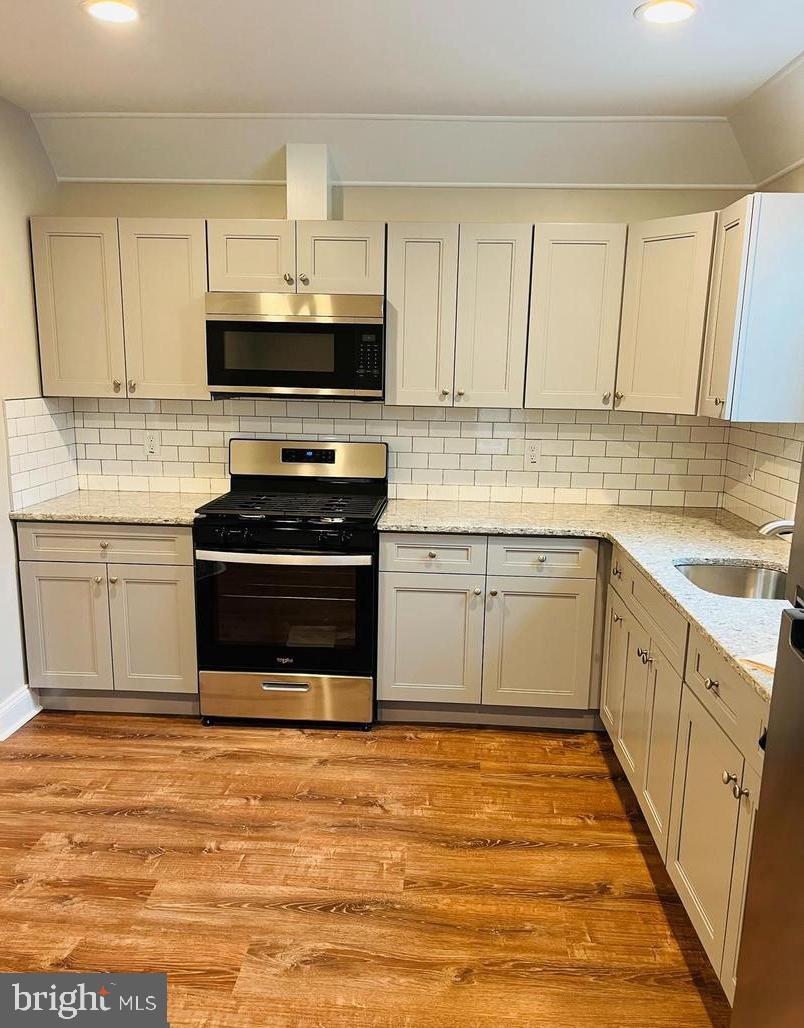 424 North Springfield Road Clifton Heights, PA 19018 - Photo 2 of 24 a kitchen with stainless steel appliances a stove sink and cabinets