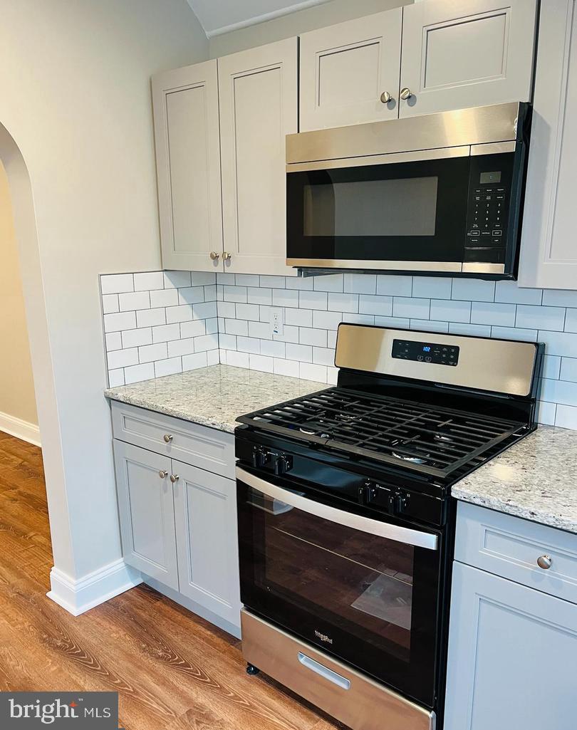 424 North Springfield Road Clifton Heights, PA 19018 - Photo 4 of 24 a kitchen with stainless steel appliances granite countertop a stove microwave and oven