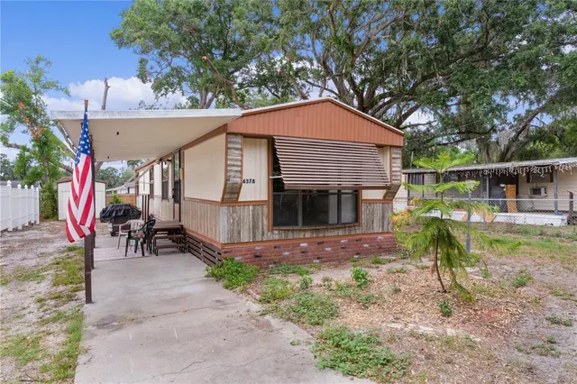 a view of house with a yard