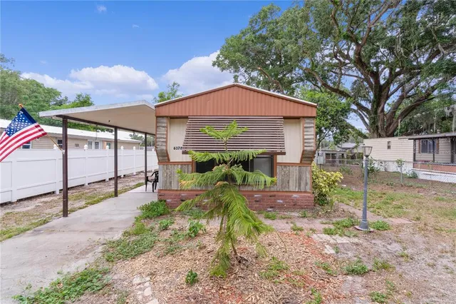 a backyard of a house with plants and outdoor seating