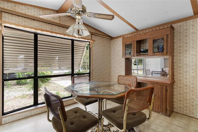 a dining room with furniture and a window