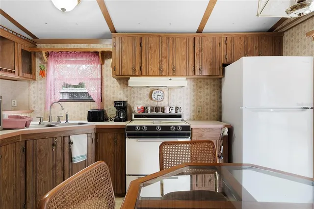 a kitchen with a stove a refrigerator and a sink