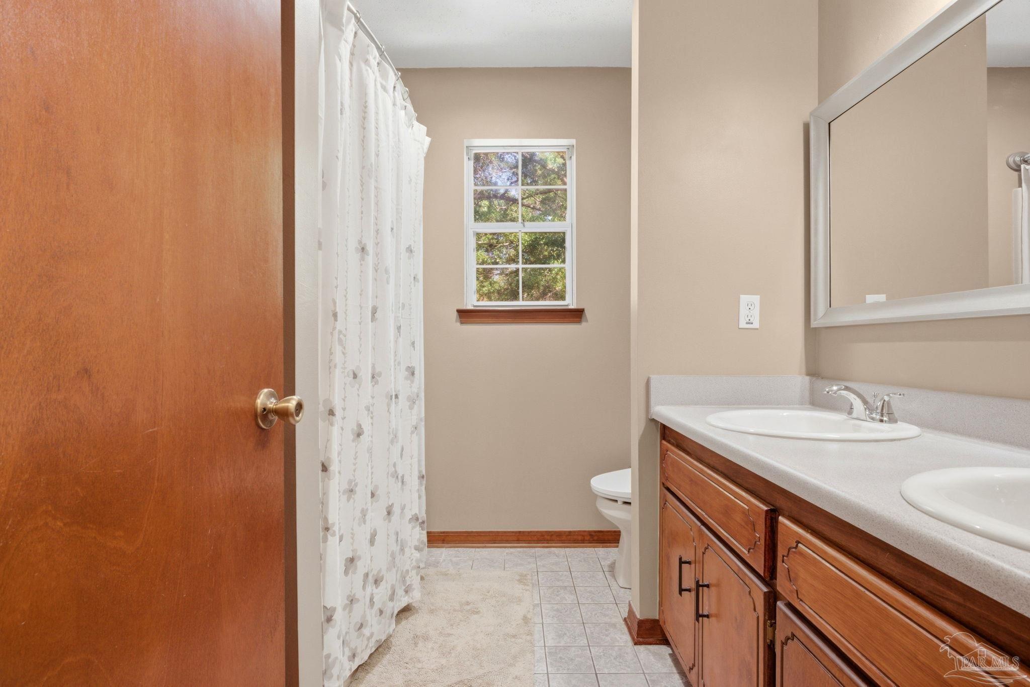 6870 Martin Road Milton, FL 32570 - Photo 23 of 48 a bathroom with a sink a toilet and shower