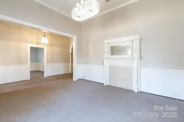 an empty room with chandelier fan