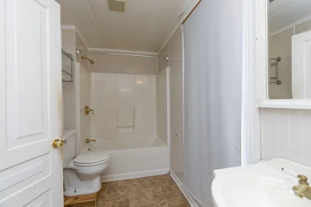 a bathroom with a toilet and shower