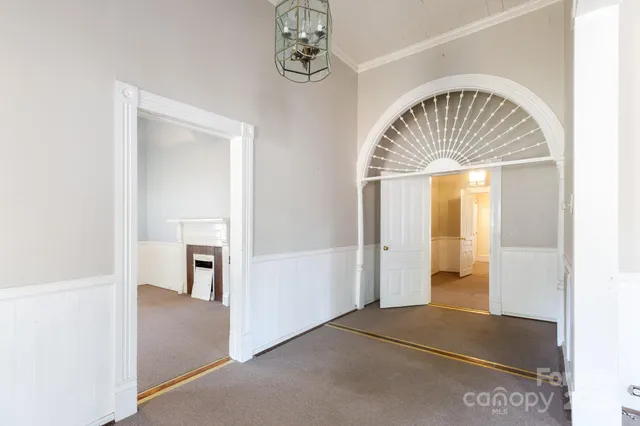 a view of hall way with furniture