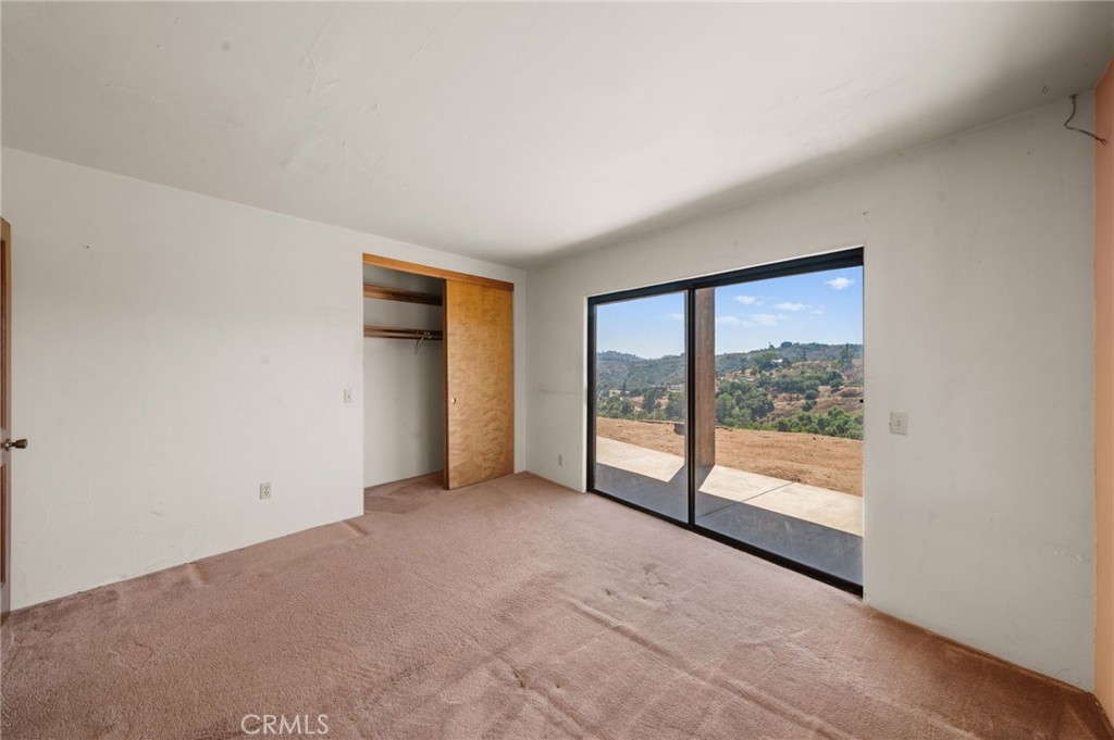 879 Stewart Canyon Road Fallbrook, CA 92028 - Photo 13 of 75 a view of an empty room with a window