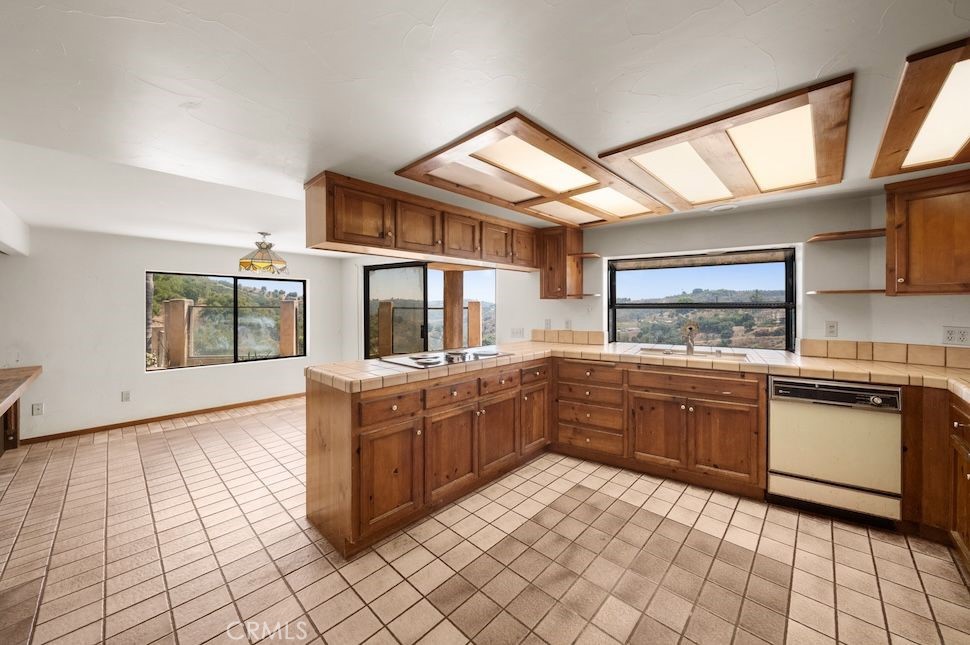 879 Stewart Canyon Road Fallbrook, CA 92028 - Photo 21 of 75 a kitchen with stainless steel appliances granite countertop a stove and a sink