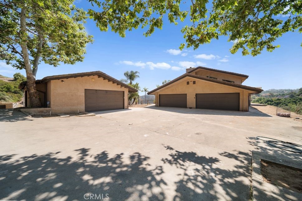879 Stewart Canyon Road Fallbrook, CA 92028 - Photo 9 of 75 a front view of a house with a yard and garage