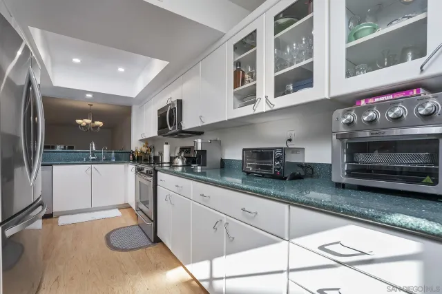 a kitchen with granite countertop a sink and cabinets