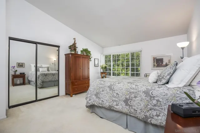 a bedroom with a large bed and a large window