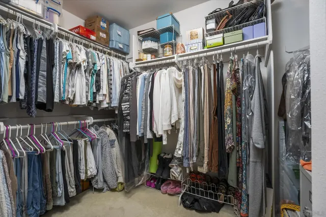 a view of walk in closet with clothes