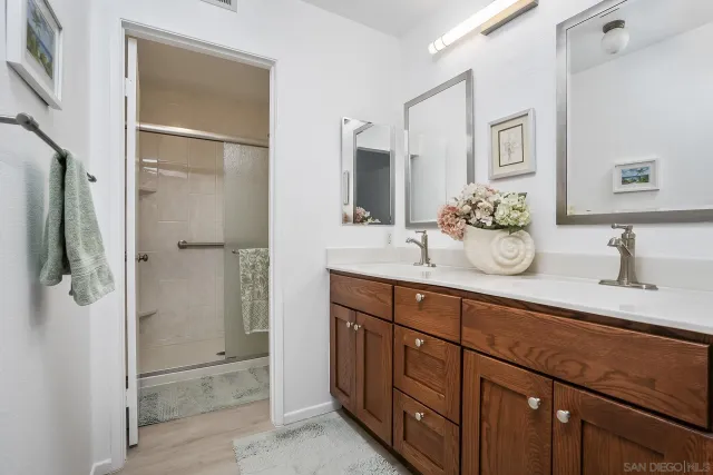a bathroom with a shower sink and mirror