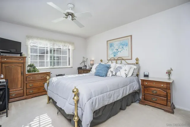 a bedroom with a bed dresser and a window