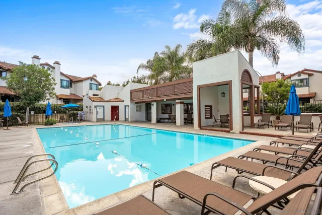 a view of a house with swimming pool and sitting area