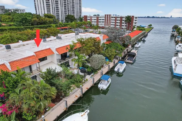 an aerial view of a house with a yard and lake view