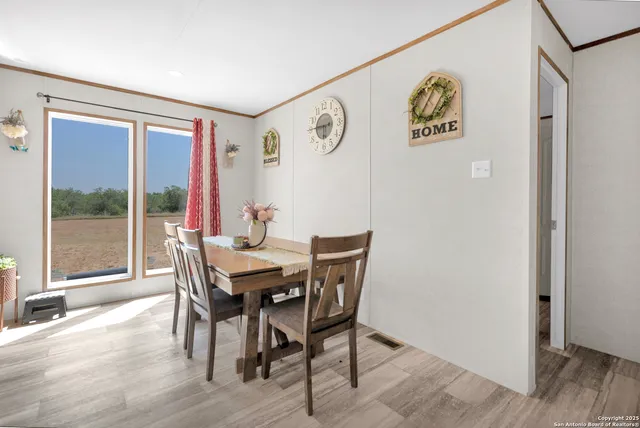 a view of a dining room with furniture window and wooden floor