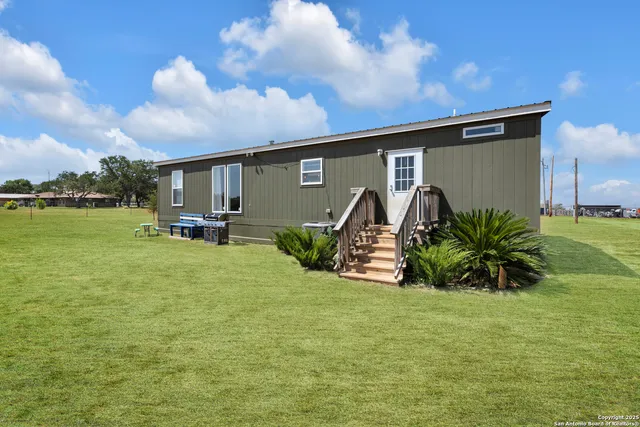 a big house with a big yard and large trees